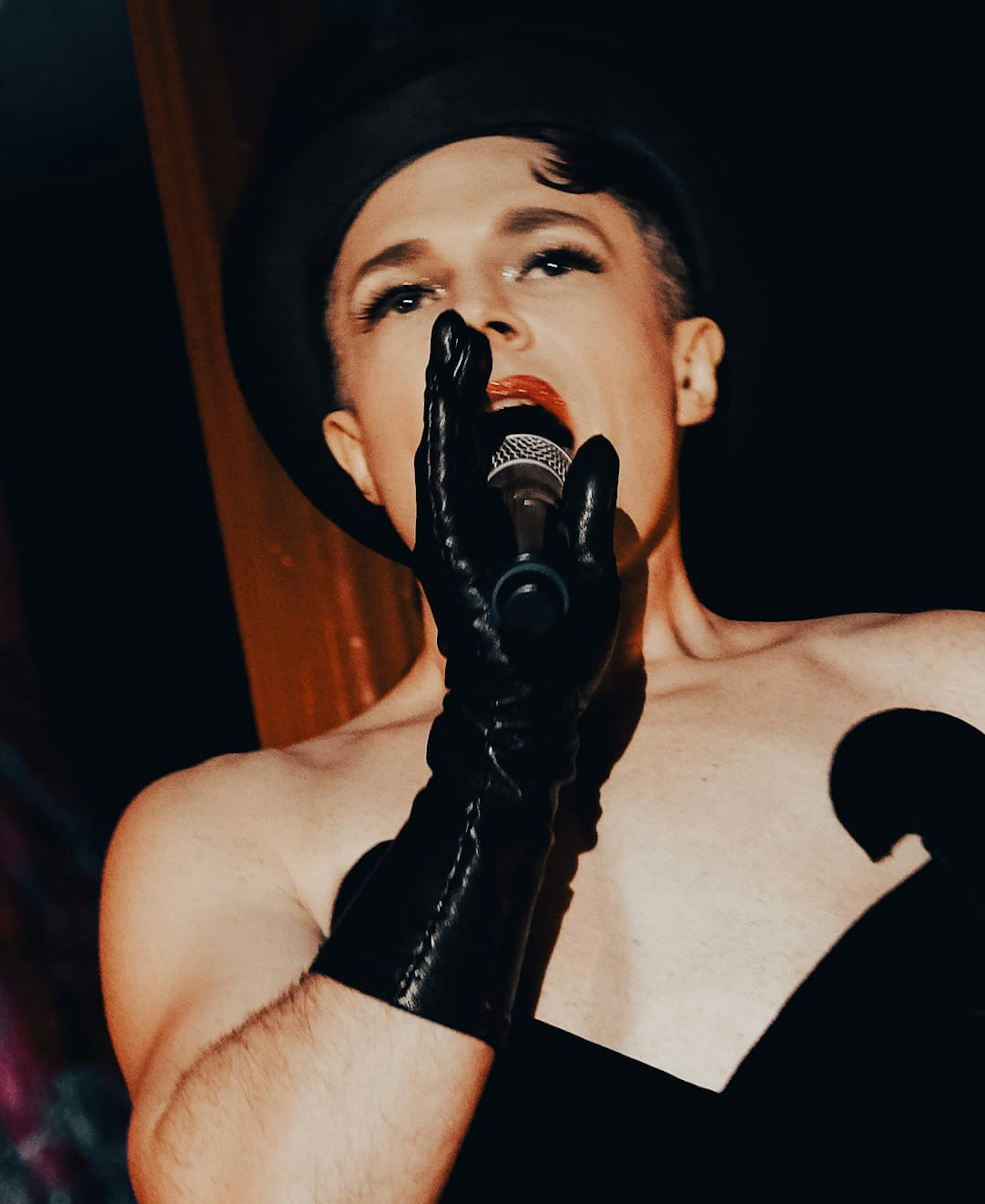This is a striking, close-up photograph featuring a performer.